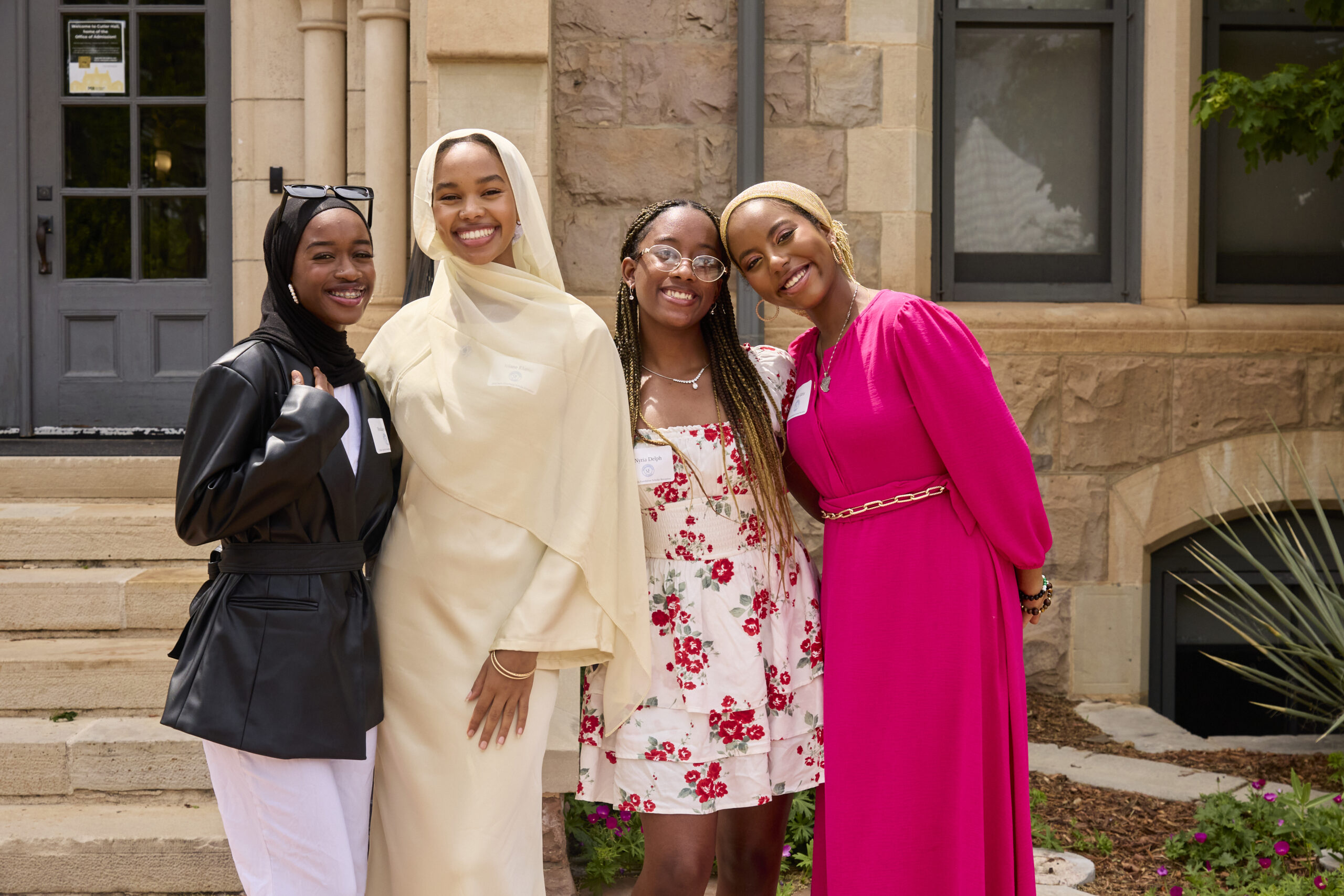 4 Sachs Scholars pose in front of Colorado College campus for a photo after celebrating receiving the Sachs Foundation Undergraduate Scholarship